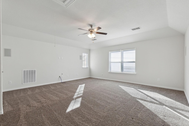 carpeted spare room featuring ceiling fan and lofted ceiling