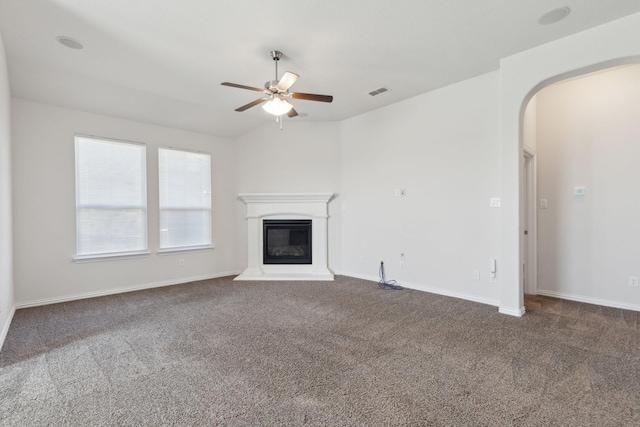 unfurnished living room with ceiling fan, lofted ceiling, and carpet floors