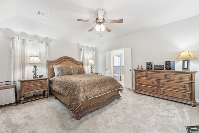 carpeted bedroom with ceiling fan and connected bathroom