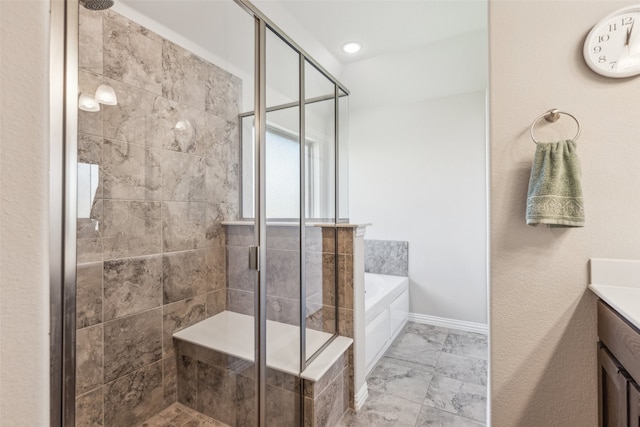 bathroom with vanity and independent shower and bath