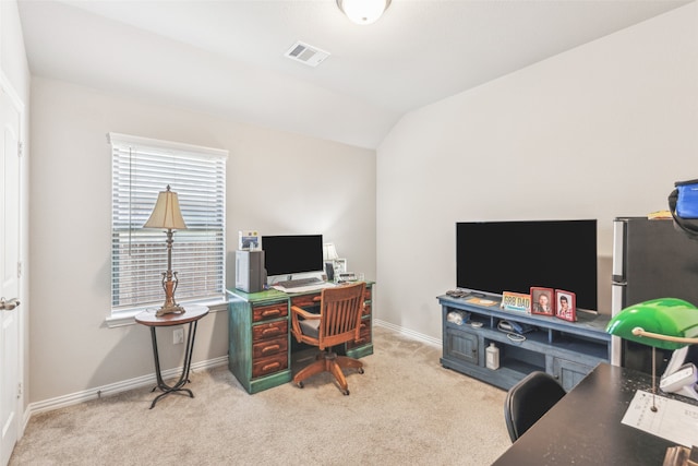 home office featuring light carpet and lofted ceiling