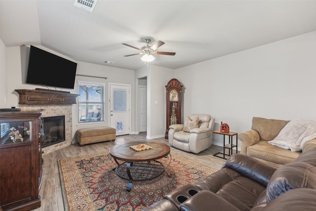 living room with ceiling fan and light hardwood / wood-style floors