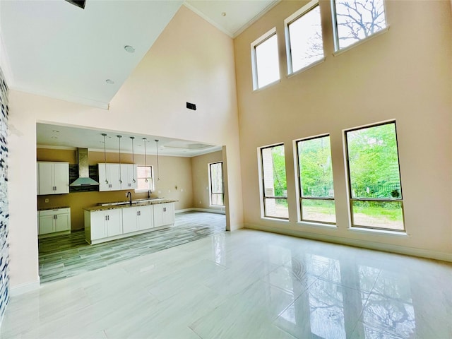 living room with sink, a high ceiling, and light tile patterned flooring