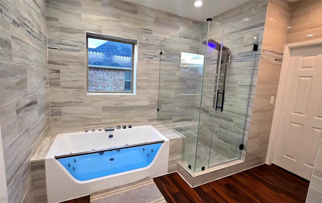 bathroom featuring independent shower and bath and hardwood / wood-style floors