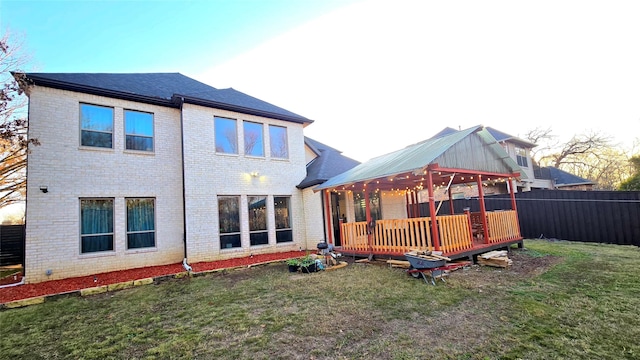 back of property with a lawn, a gazebo, and a deck