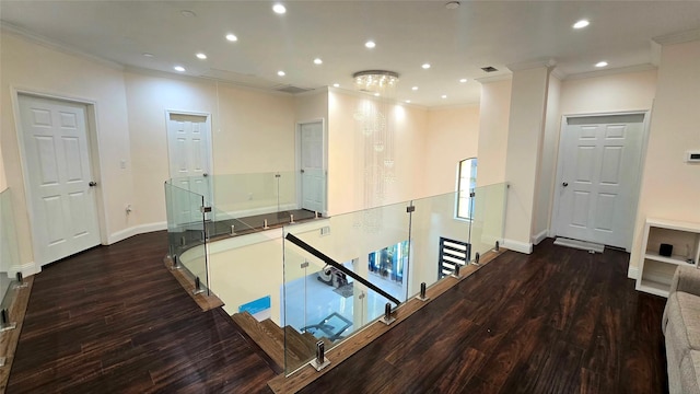 corridor featuring hardwood / wood-style floors and crown molding