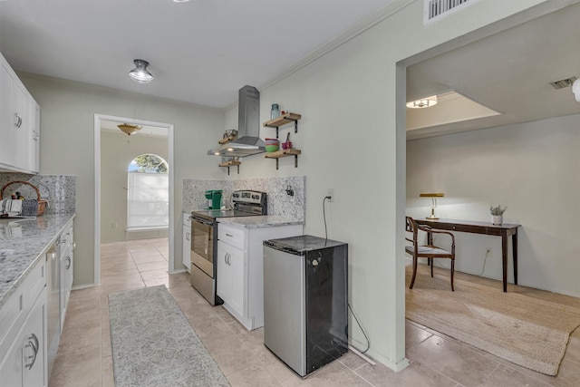 kitchen with white cabinets, appliances with stainless steel finishes, island exhaust hood, decorative backsplash, and light stone counters