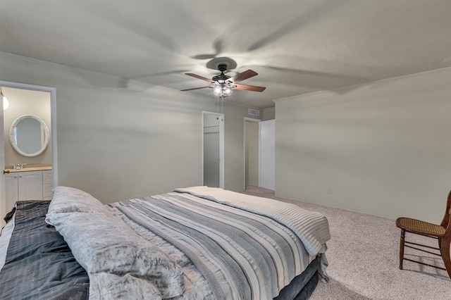 carpeted bedroom with ceiling fan, crown molding, and connected bathroom