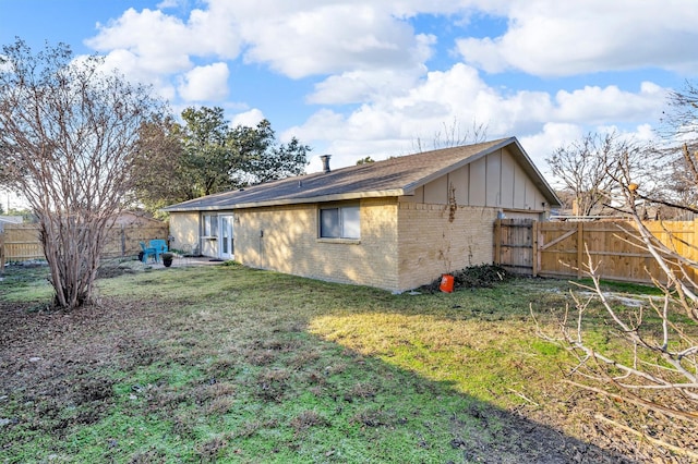 view of side of home with a yard