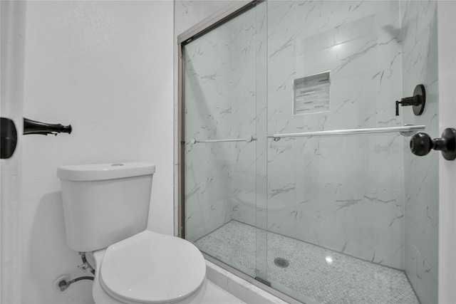 bathroom featuring toilet and an enclosed shower