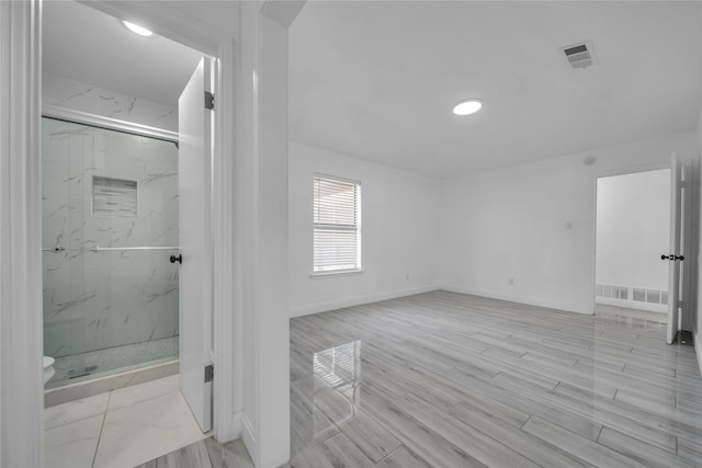 bathroom featuring a shower with door