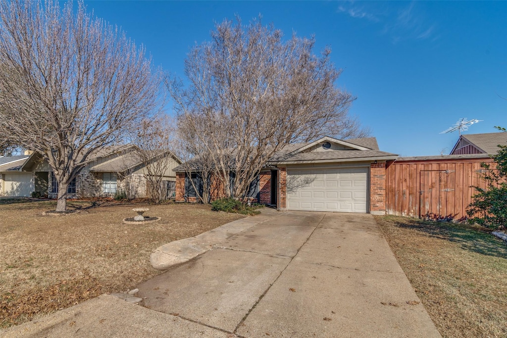 ranch-style home featuring a front yard and a garage