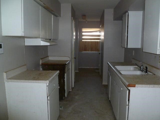 kitchen featuring sink and white cabinetry