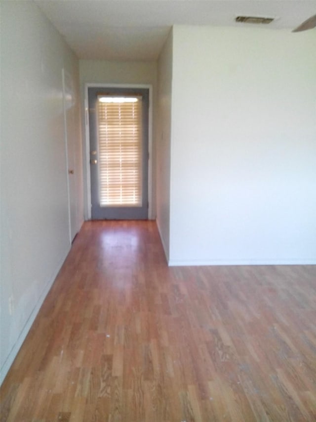 corridor featuring wood-type flooring