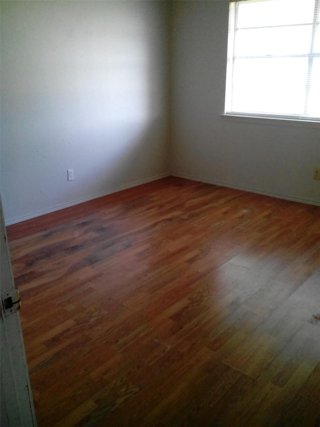 unfurnished room featuring dark wood-type flooring