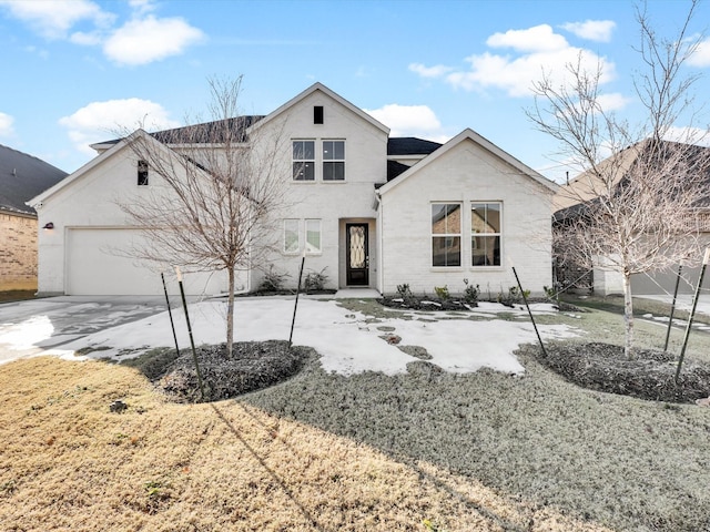 view of front of property with a front lawn and a garage