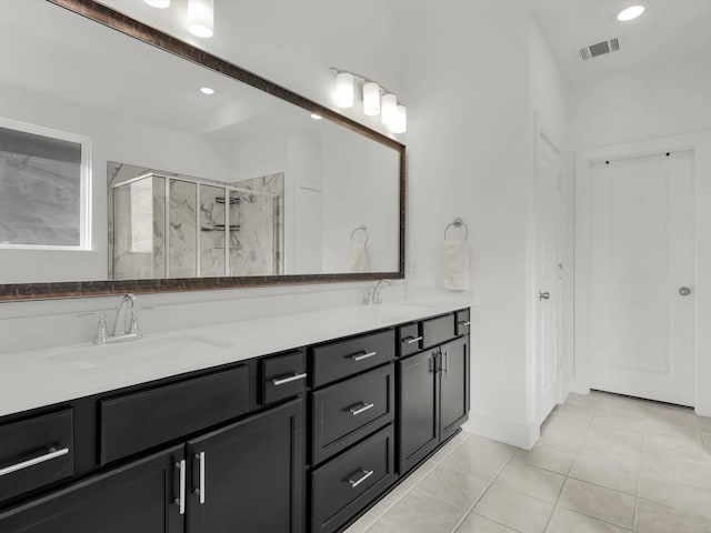 bathroom featuring vanity, tile patterned flooring, and a shower with shower door