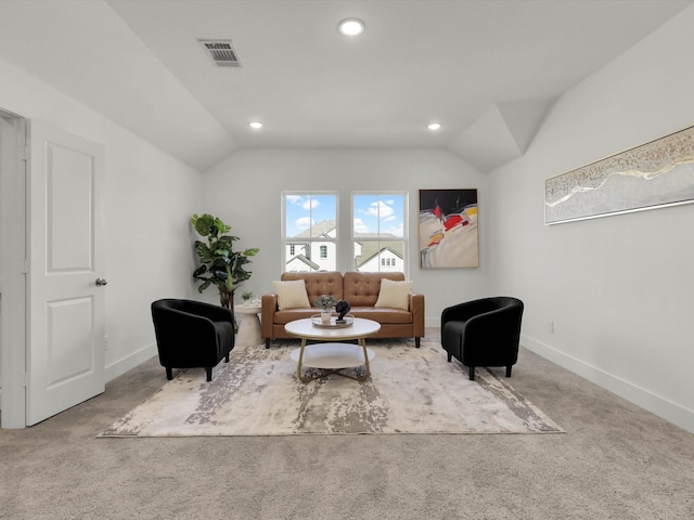 sitting room featuring vaulted ceiling and light carpet