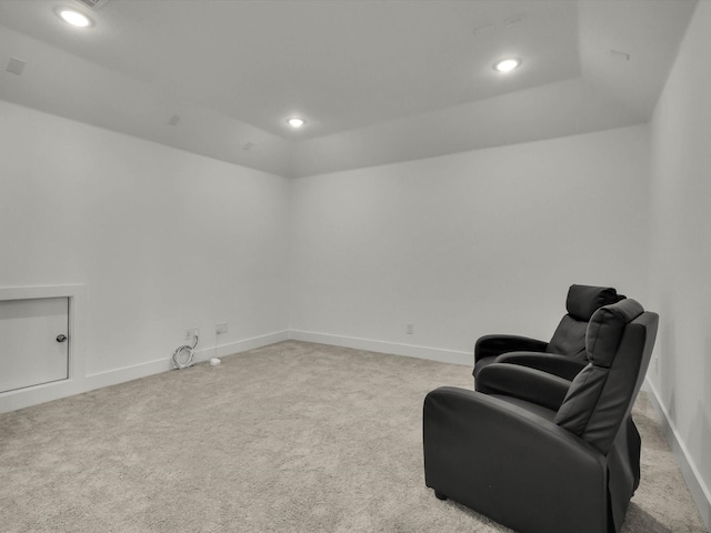 living area featuring lofted ceiling and light colored carpet