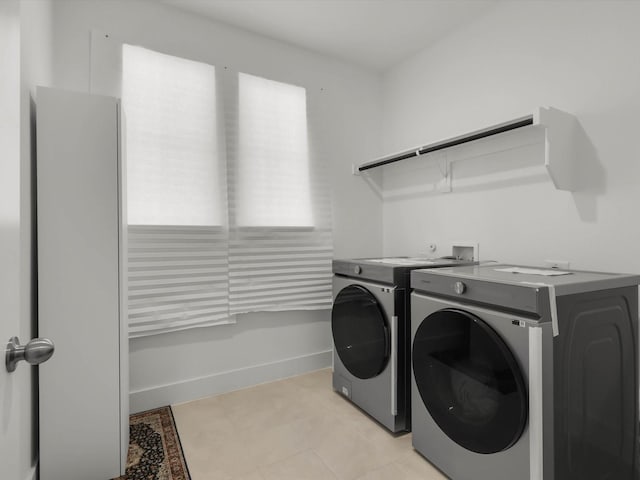 washroom with light tile patterned flooring and independent washer and dryer