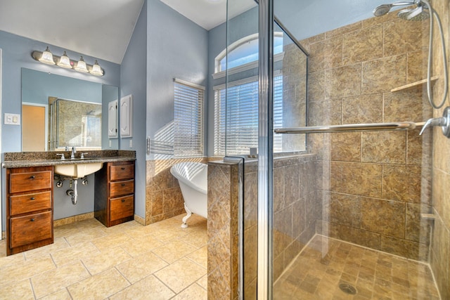 full bath with tile patterned floors, a freestanding tub, vanity, and a shower stall