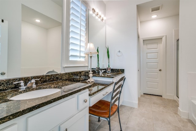 bathroom featuring vanity, tile patterned flooring, and walk in shower