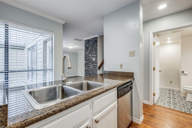 kitchen with sink, white cabinets, light hardwood / wood-style floors, stainless steel dishwasher, and crown molding