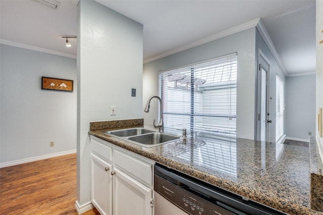 kitchen featuring sink, white cabinetry, dishwasher, dark stone countertops, and crown molding