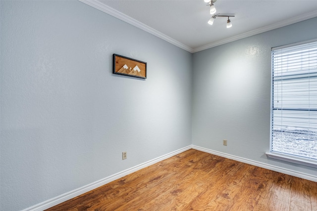 unfurnished room featuring ornamental molding and hardwood / wood-style floors