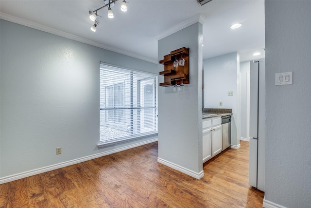 kitchen with dishwasher, light hardwood / wood-style flooring, a wealth of natural light, white cabinets, and ornamental molding