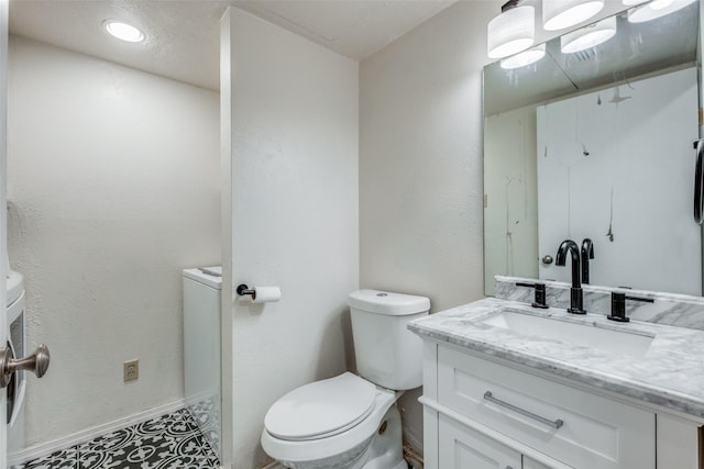 bathroom featuring toilet and vanity