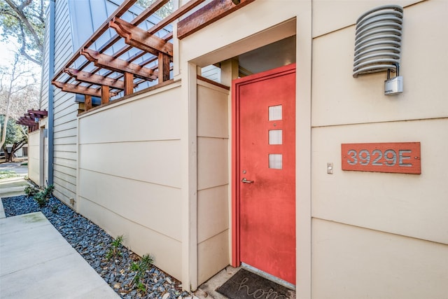 property entrance with a pergola