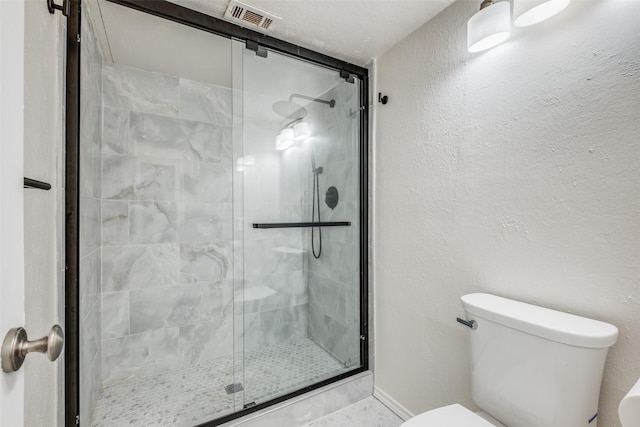 bathroom featuring walk in shower and toilet