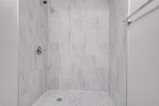 bathroom with a tile shower