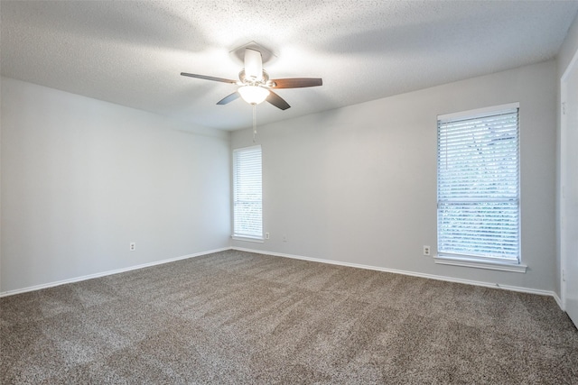 empty room with a textured ceiling, carpet floors, and ceiling fan