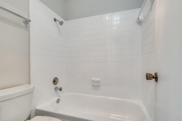 bathroom with bathing tub / shower combination and toilet