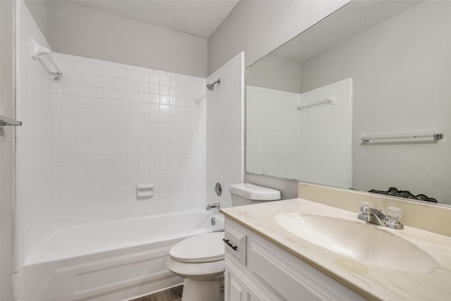 full bathroom with toilet, hardwood / wood-style flooring, a textured ceiling, tiled shower / bath, and vanity