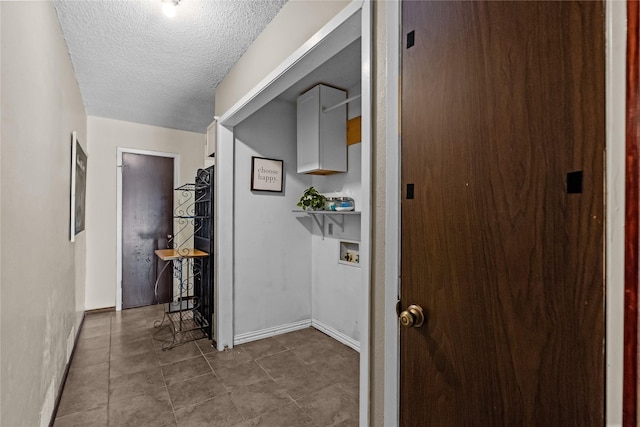 hallway with a textured ceiling