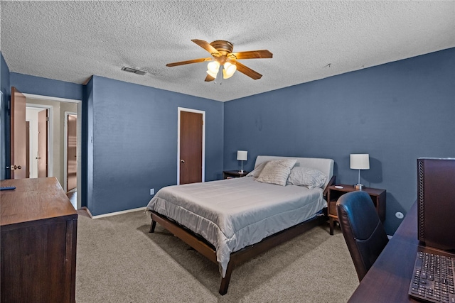 carpeted bedroom with ceiling fan and a textured ceiling