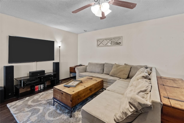 living room featuring ceiling fan and a textured ceiling