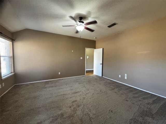 carpeted spare room with lofted ceiling, a textured ceiling, and ceiling fan