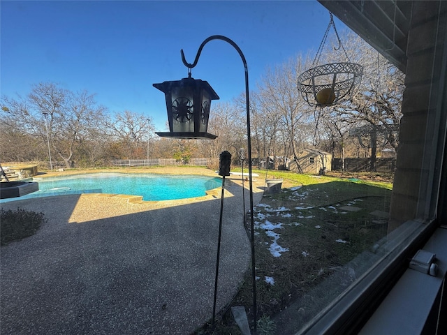 view of pool featuring a storage shed