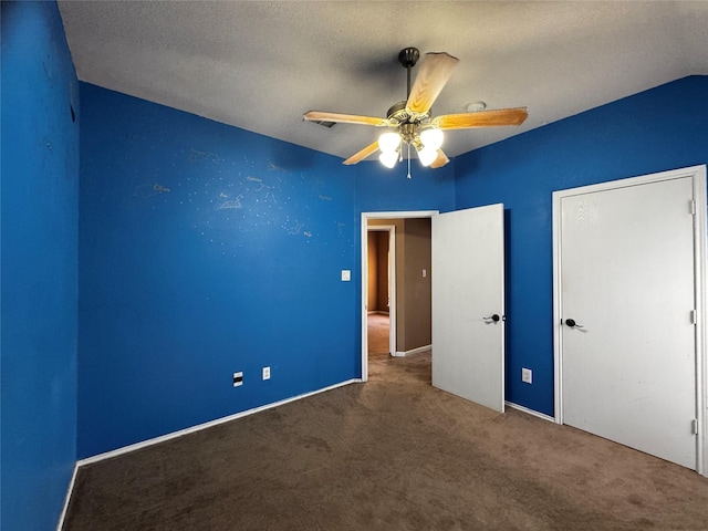 unfurnished bedroom featuring ceiling fan, carpet floors, and a textured ceiling