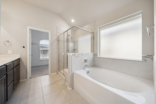 bathroom with lofted ceiling, tile patterned floors, separate shower and tub, and vanity