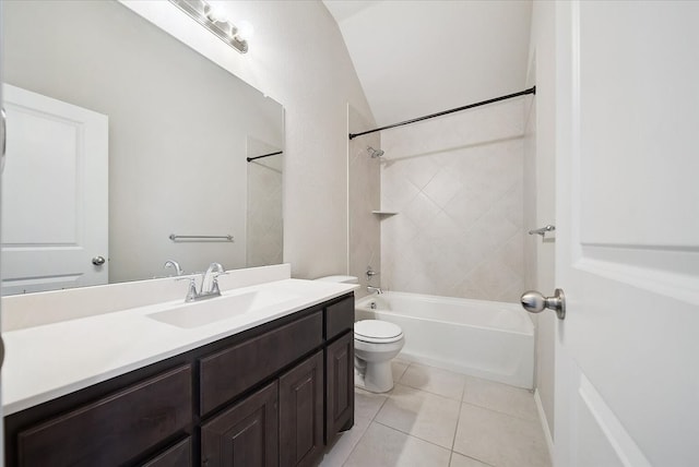 full bathroom featuring vaulted ceiling, tiled shower / bath, toilet, tile patterned floors, and vanity