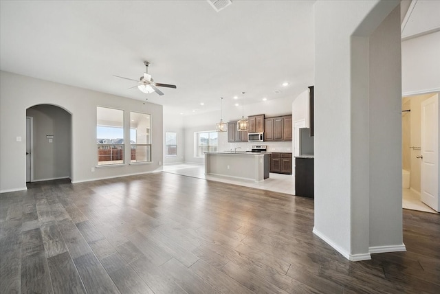 unfurnished living room with hardwood / wood-style floors and ceiling fan