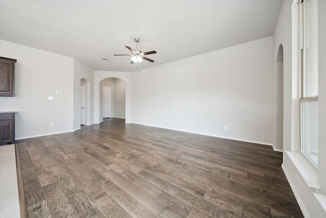 unfurnished living room with ceiling fan and hardwood / wood-style floors