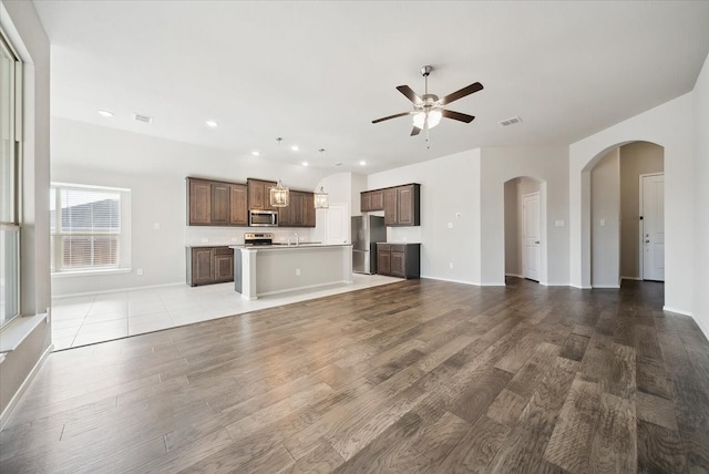 unfurnished living room featuring light hardwood / wood-style floors and ceiling fan