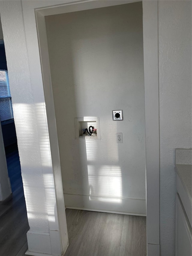 washroom featuring hookup for a washing machine, electric dryer hookup, and wood-type flooring