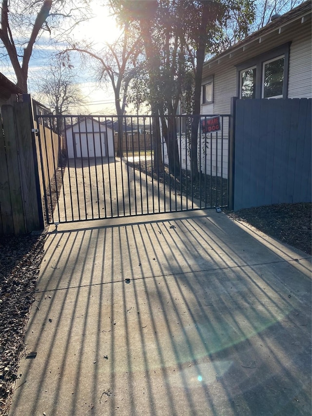 view of gate featuring an outbuilding